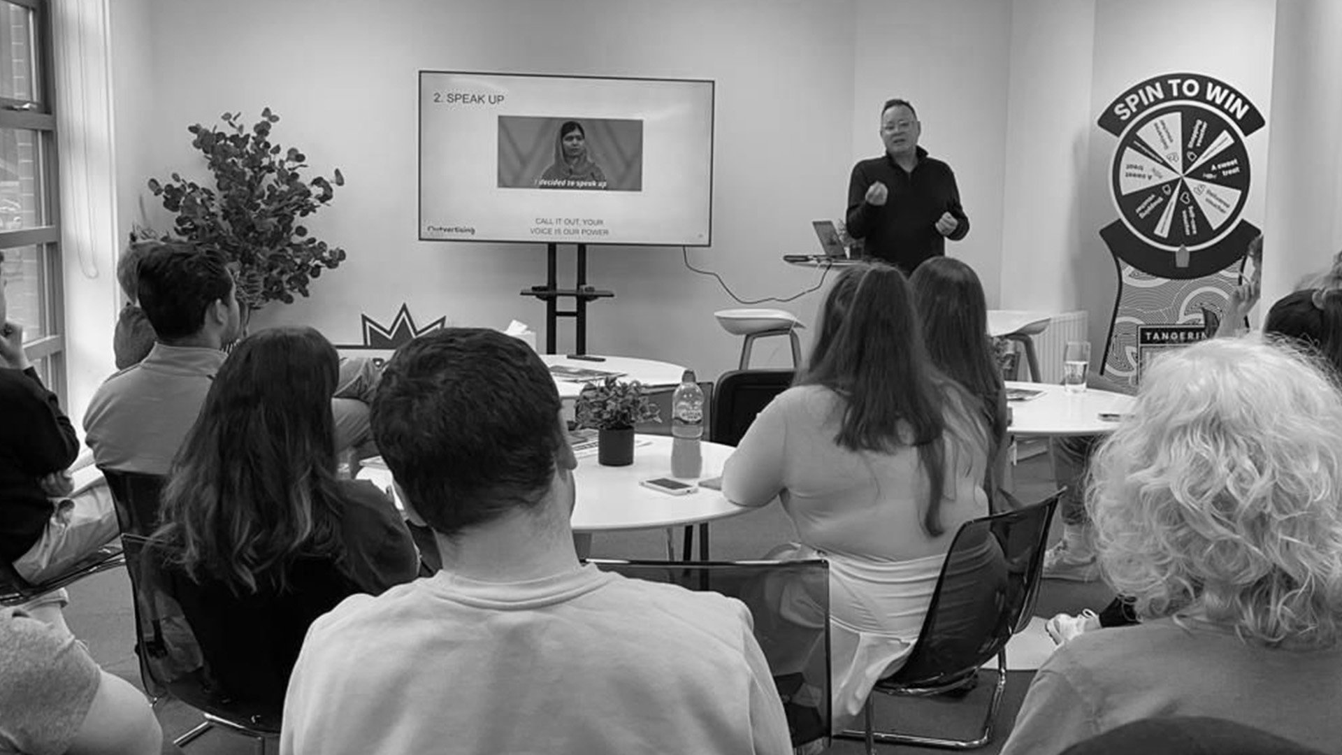 Team watching a presenter during an internal training session