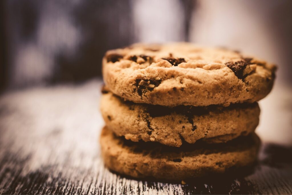 Stack of chocolate chip cookies on a wooden table, illustrating the end of third-party cookies