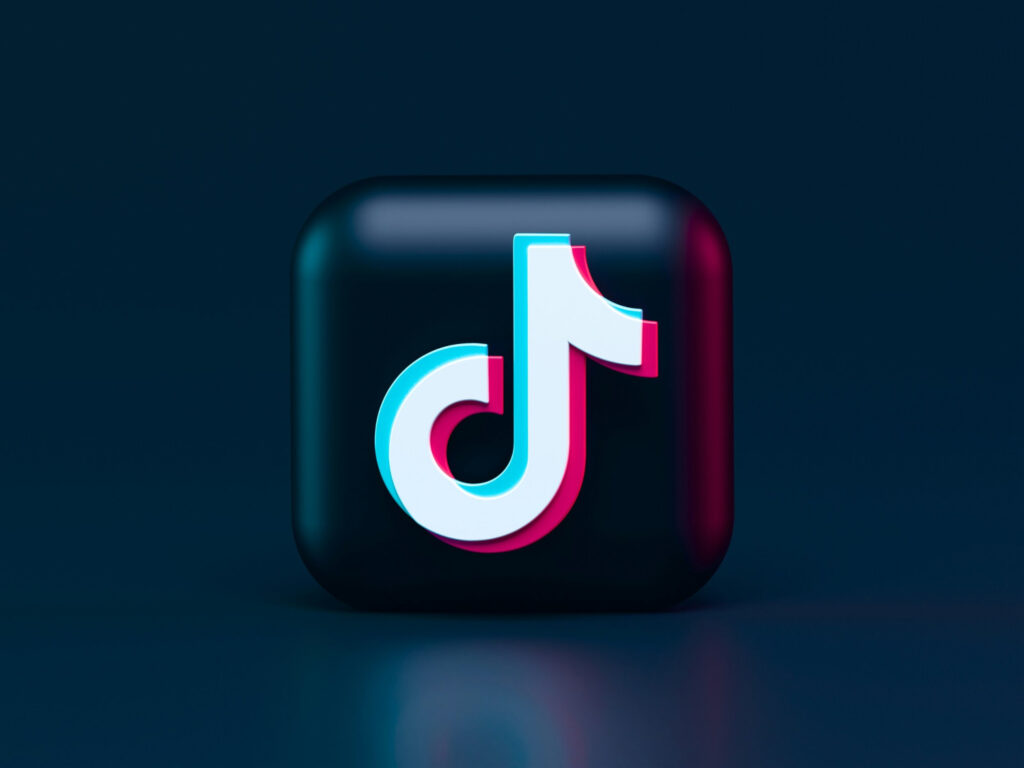 TikTok logo on a dark glossy app icon