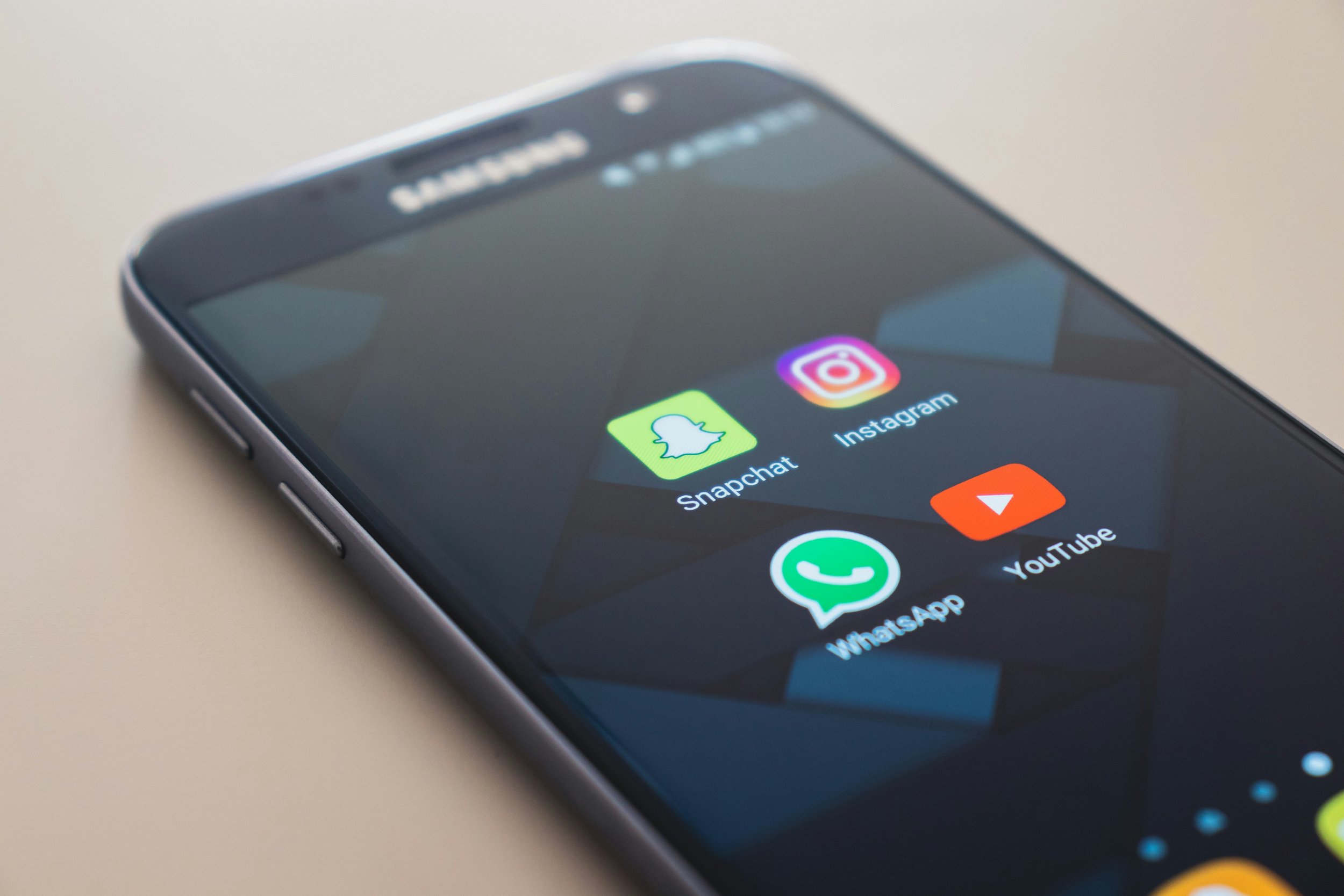Smartphone screen showing Snapchat, Instagram, WhatsApp and YouTube apps