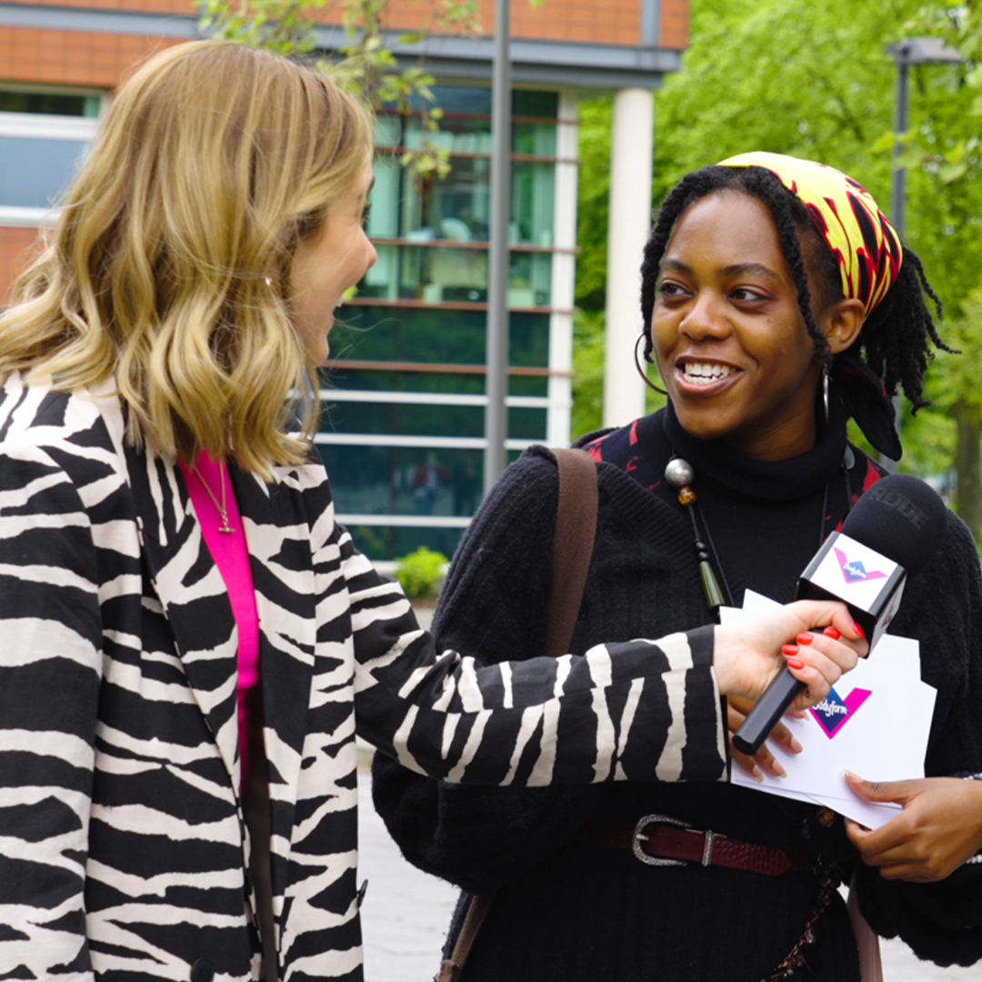 Presenter in a zebra-print jacket interviewing a woman on the street for Bodyform