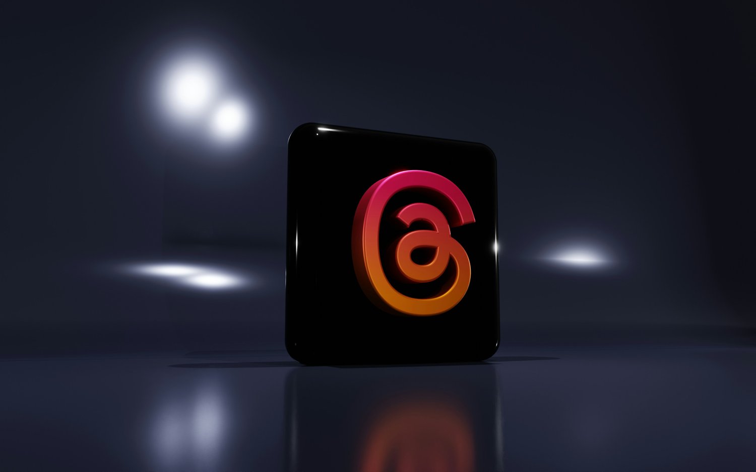 Threads app logo on a glossy black cube