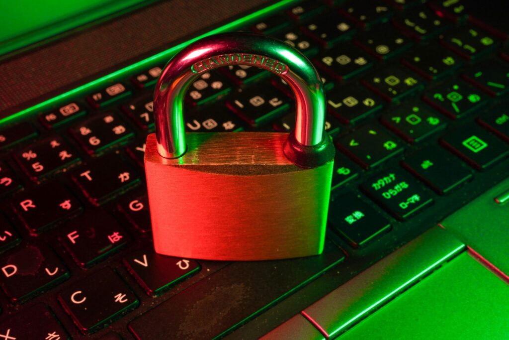 Red padlock on a laptop keyboard lit in green