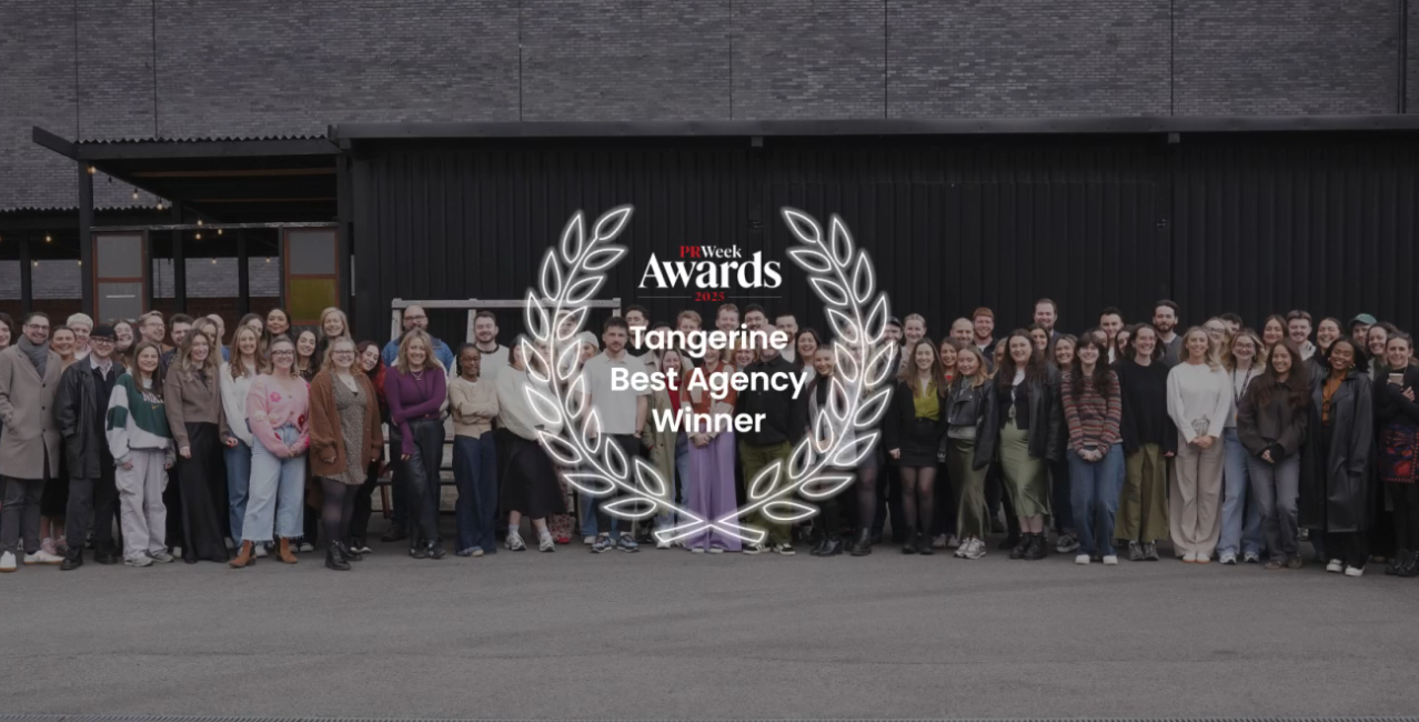 Tangerine team group photo outdoors with a PRWeek Awards Best Agency winner graphic