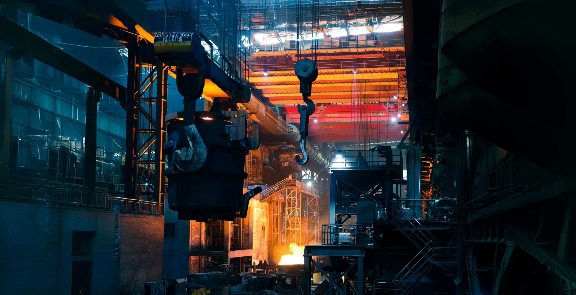 Inside a steelworks with molten metal glowing, illustrating manufacturing