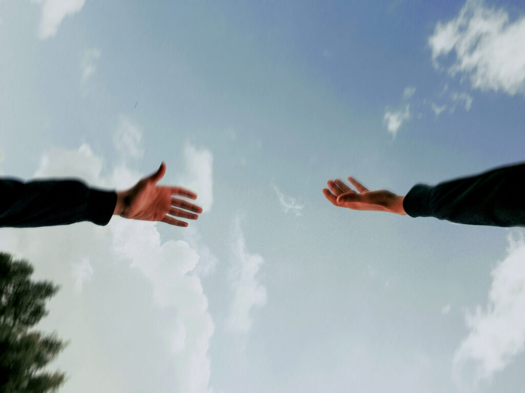 Two hands reaching towards each other against a blue sky, cover art for the Unretrievable report