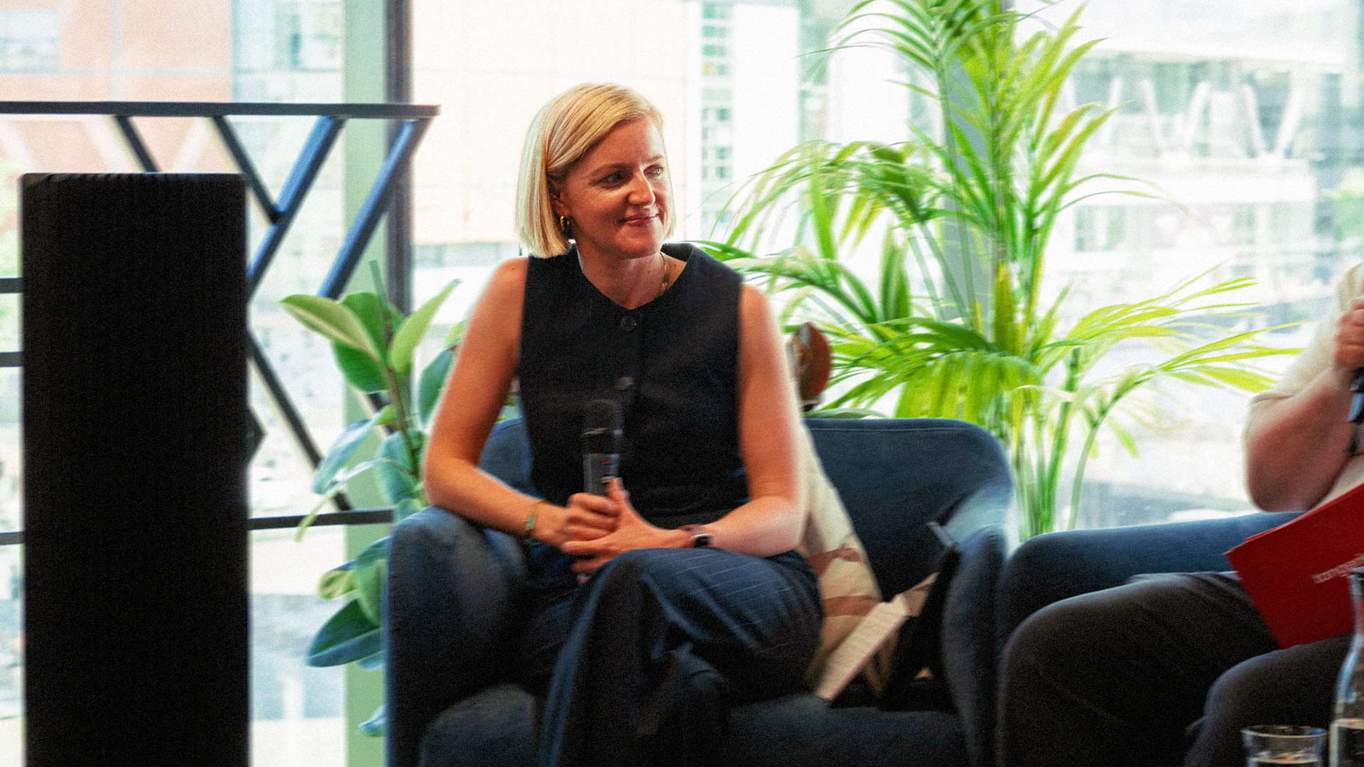 Woman speaking on a panel at a Tangerine event