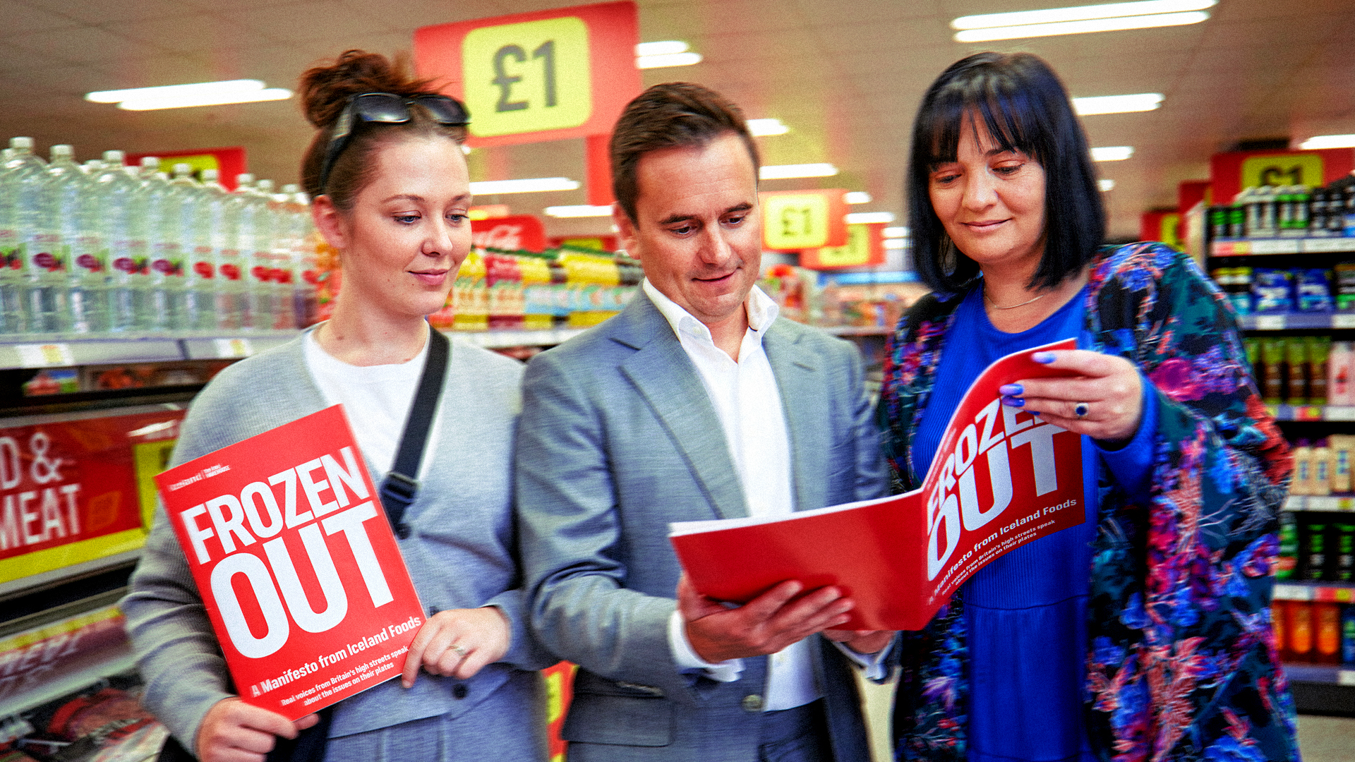 Iceland team reading the 'Frozen Out' report in a store aisle