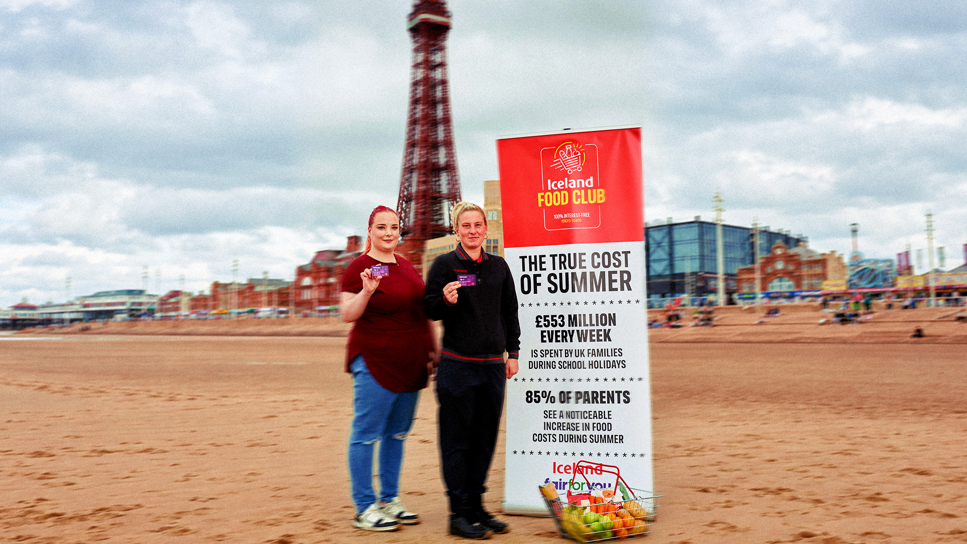 Iceland team on Blackpool beach beside a 'True cost of summer' board
