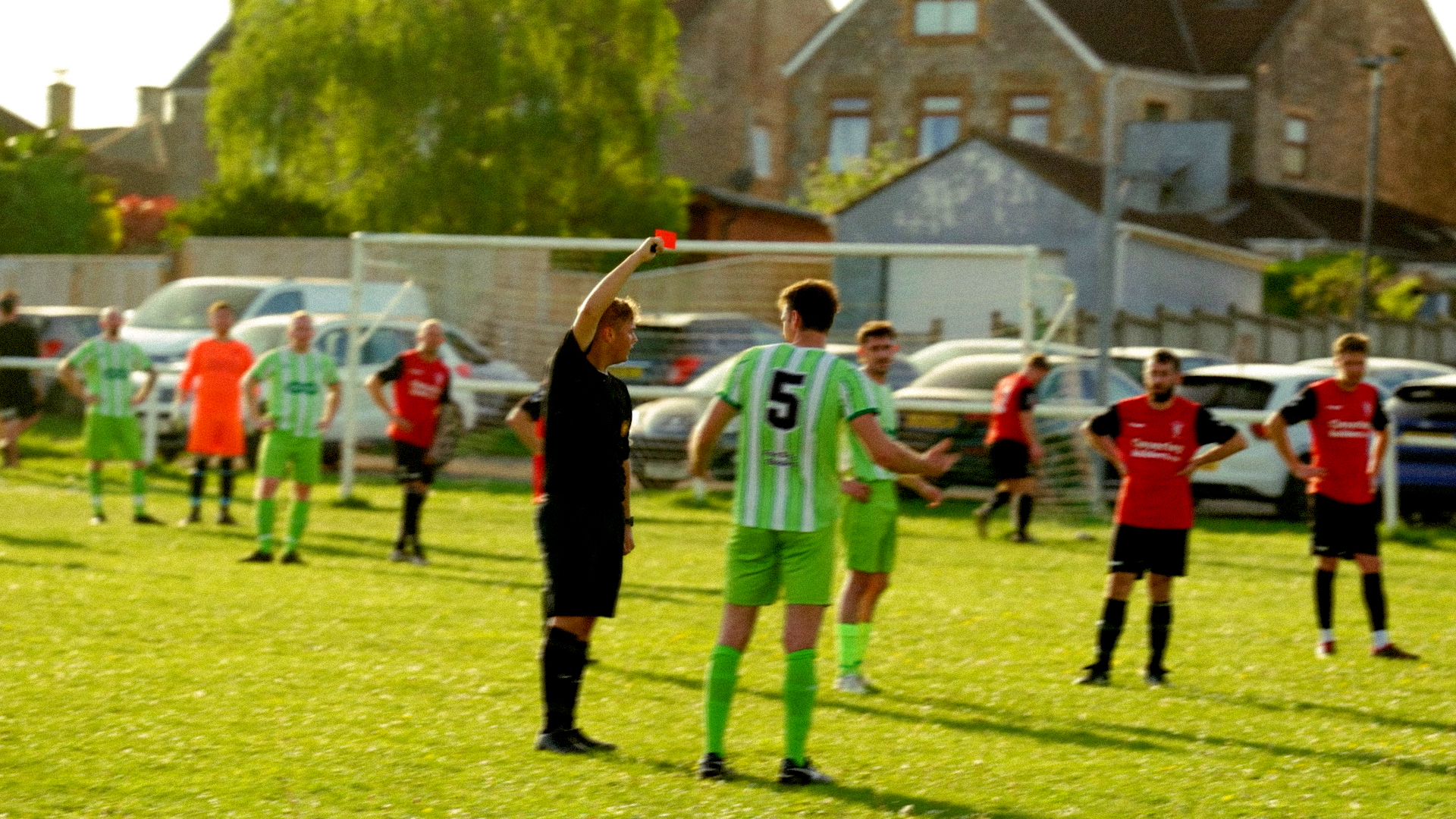 Referee showing a red card during a grassroots football match