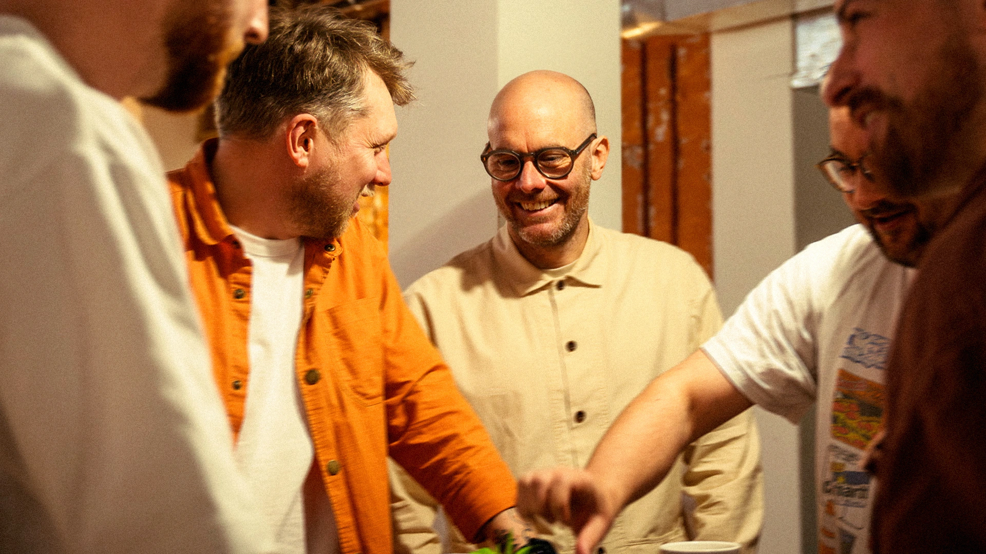 Tangerine team members joining hands in a huddle