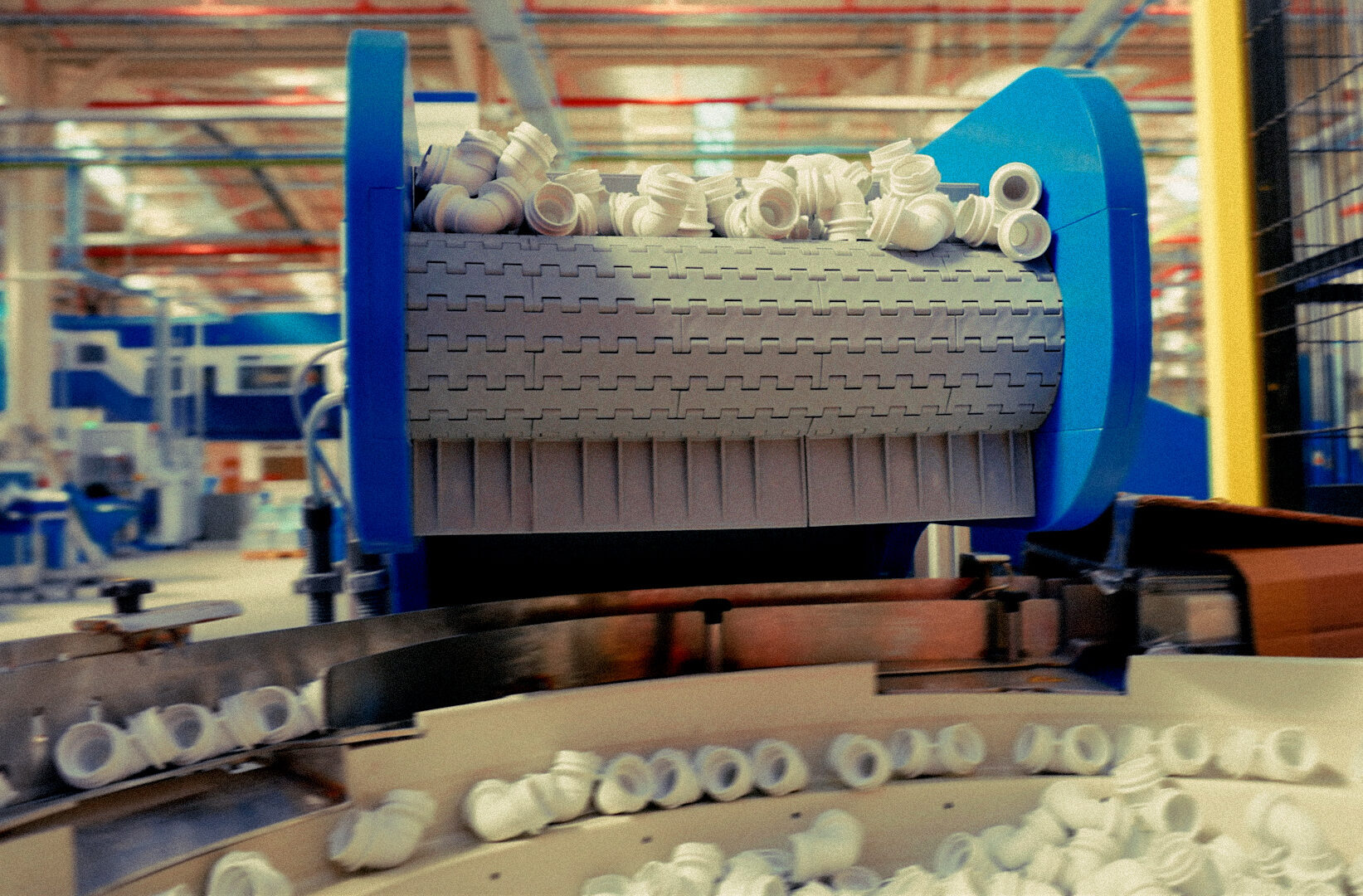 White plumbing fittings moving along a production line at the Wavin factory